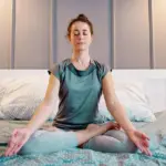 woman-practising-yoga-on-the-bed-1296x728-header
