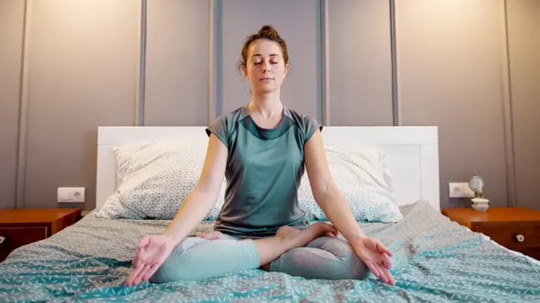 woman-practising-yoga-on-the-bed-1296x728-header